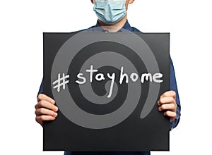 Man with #stayhome message on blackboard