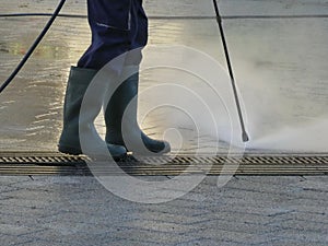 Man steam cleaning street with pressure