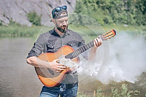 Man with a steaming acoustic guitar