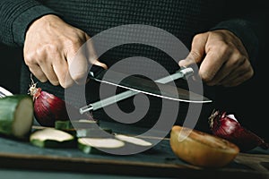 man steels a kitchen knife