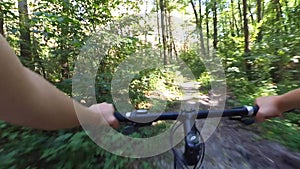 Man steering arms caucasian bike ride in the forest in summer
