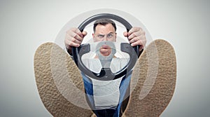 Man with a steering wheel, front view. Driver car concept