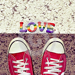 Man stepping on the asphalt and the word love