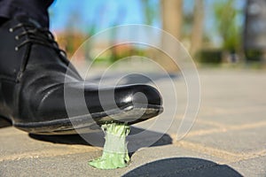 Man stepping in chewing gum on sidewalk