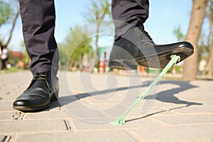 Man stepping in chewing gum on sidewalk