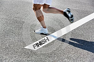 Man stepping on finish line