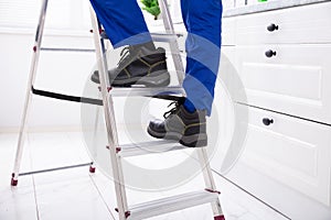 Man Stepping On Ladder