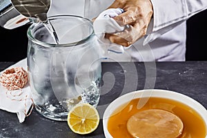 Man sterilising a glass jar with boiling water