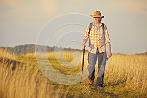 Man with stick on way