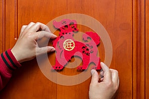 Man sticking a Chinese New Year of the Dog 2018 to door