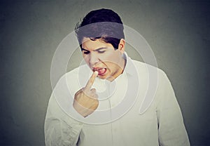 Man sticking finger in mouth about to throw up something sucks