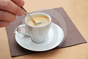 Man stiring an espresso