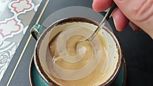 Man stirring sugar in coffee