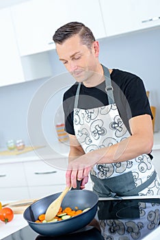 Man stirring the vegetables