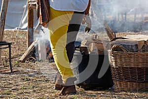 Man Stoking the Fire at a Historical Reenactment