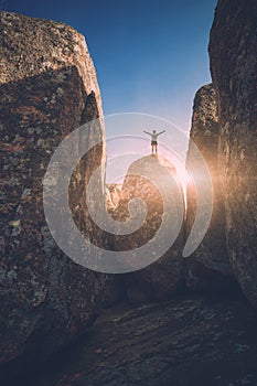 Man on a stone in a deep canyon. Instagram stylization