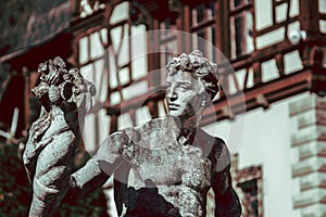 Man Stone Sculpture in Front Of Castle