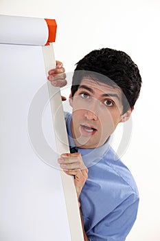 Man stood by blank flip-chart
