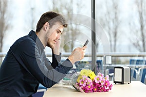 Man stood up in a date checking phone messages