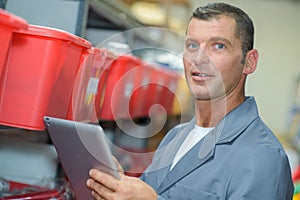 Man in storeroom with tablet