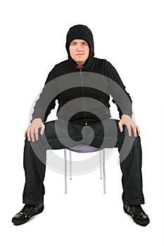Man is strained, sits on a chair