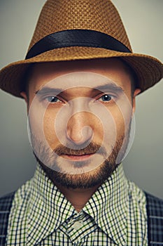 Man in straw hat and checked shirt