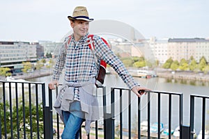Man in straw hat standing on a terrace against Helsinki, Finland
