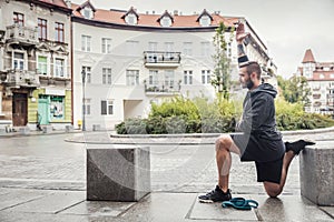 Man streching his legs in the city