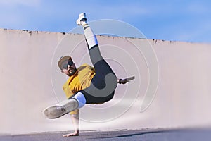 Man street Break Dancer is Dancing in the street. BBOY makes an acrobatic element Flare