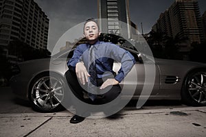 Man on the street with his luxury sports car