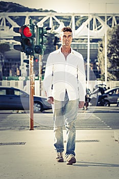 Man in street photography. Walking on sidewalks. Red light