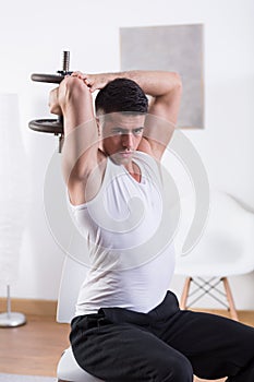 Man strengthening triceps muscle photo