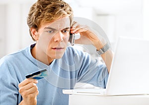 Man, stress and phone call for credit card in home for fraud, finance and website glitch for online shopping. Male