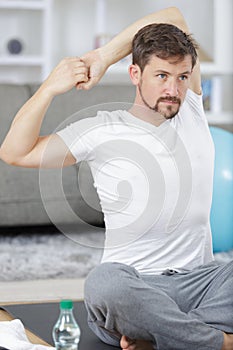 Man stretching arms before exercising