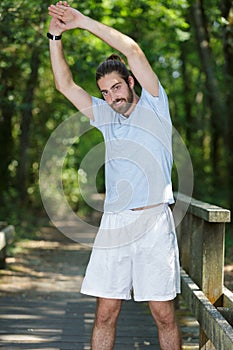 man stretching arms outside