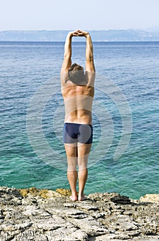 Man stretching on beach