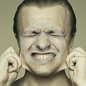 Man stretching out his cheeks