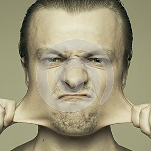 Man stretching out his cheeks