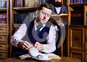 Man with strict face at tea party. Retro detective drinks