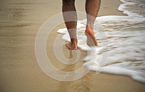 Man strolling through the surf photo