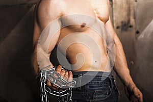 Man with strong arms and muscular male torso