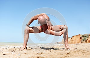 Man in strong spinal twist yoga pose