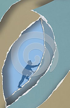 A man struggles to climb an incline made of torn paper