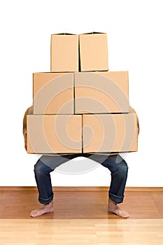 Man struggling with lots of cardboard boxes