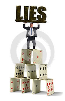 Man struggling to hold up giant stone LIES on shaky house of cards representing the dangerous situation in his web of deceit photo