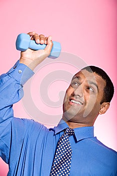 Man struggling to lift a dumbbell