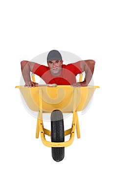 Man struggling with wheelbarrow