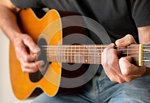 Man strumming an Acoustic Guitar