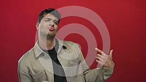 Man strums air guitar in studio; joy playfulness