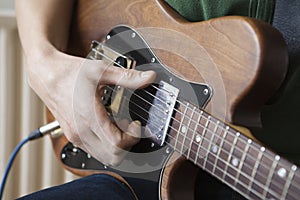 Man Strums Chord On Guitar